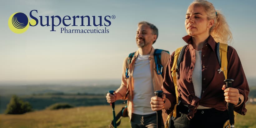 Supernus logo on left and two people with hiking poles on right